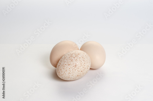 A few eggs on a white background. Broken Spotted Egg.