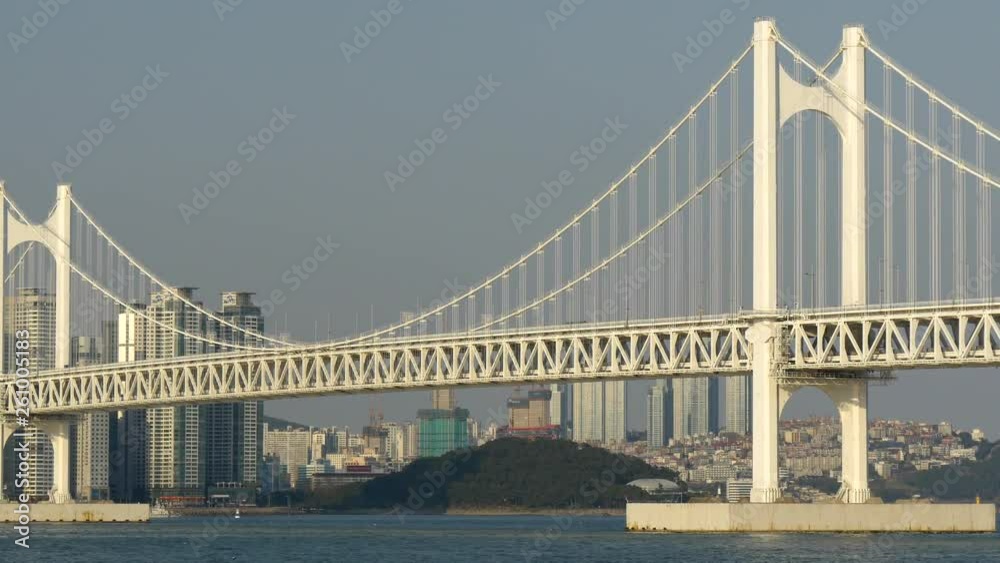 Gwangandaegyo (or Diamond) Bridge in the afternoon sun in Busan (Pusan), South Korea. Modern-shaped skyscrapers in the Haeundae District. Panning shot, UHD Gwangandaegyo (or Diamond) Bridge in the afternoon sun in Busan (Pusan), South Korea. Modern-shaped skyscrapers in the Haeundae District. Panning shot, UHD