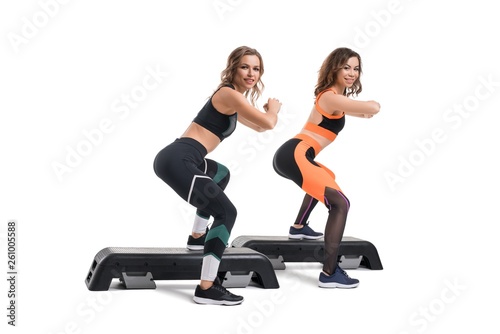 Shot of girls doing fitness on step platform