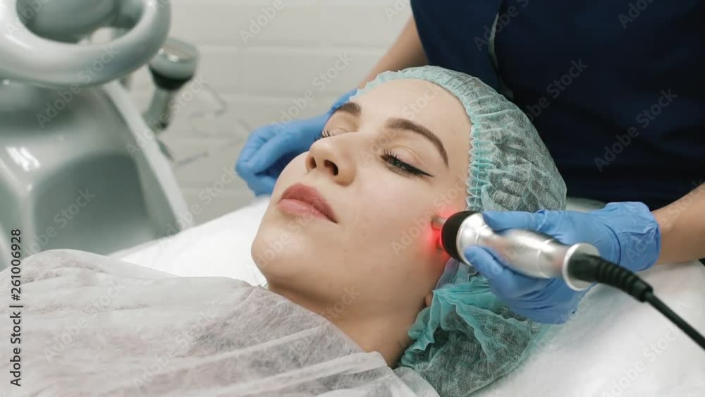 Close-up Of A Woman Cosmetologist Doing A Facial Massage Close-up Of A Woman Cosmetologist Doing A Facial Massage