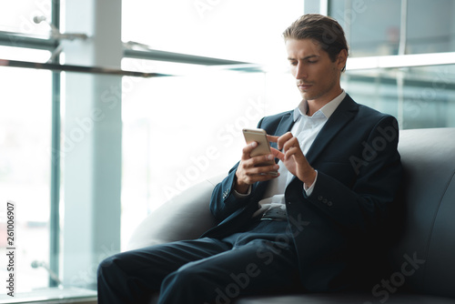 Young businessman working on a plan of Internet project on the laptop. Man discusses business matters by phone. Working computer for internet research. Digital marketing. Development