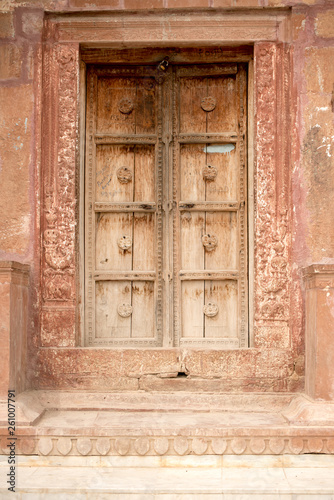 old wooden door in stone wall