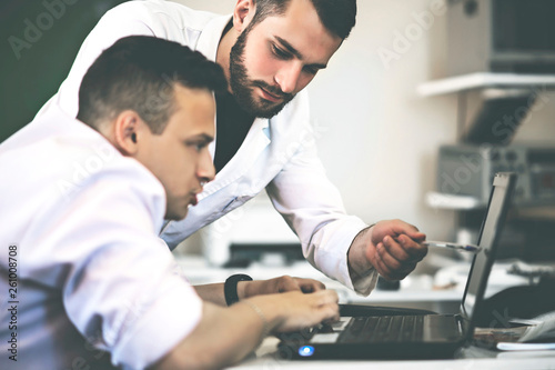 young scientists study information on a laptop