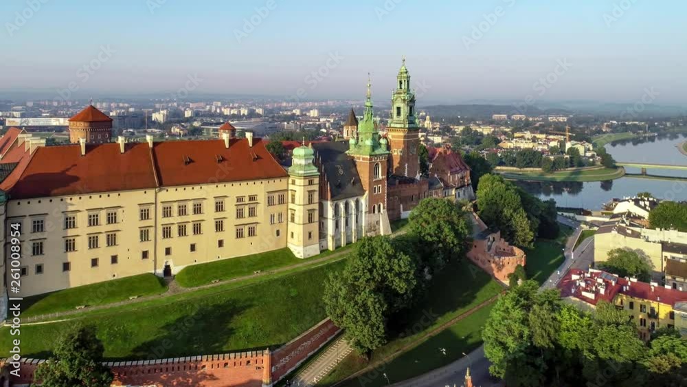 Krakow, Poland. Wawel Gothic Cathedral and belfry with the famous Sigismund Bell (Dzwon Zygmunta), renaissance castle and Vistula river in the background. Aerial 4K flyby video in sunrise light. Krakow, Poland. Wawel Gothic Cathedral and belfry with the famous Sigismund Bell (Dzwon Zygmunta), renaissance castle and Vistula river in the background. Aerial 4K flyby video in sunrise light.