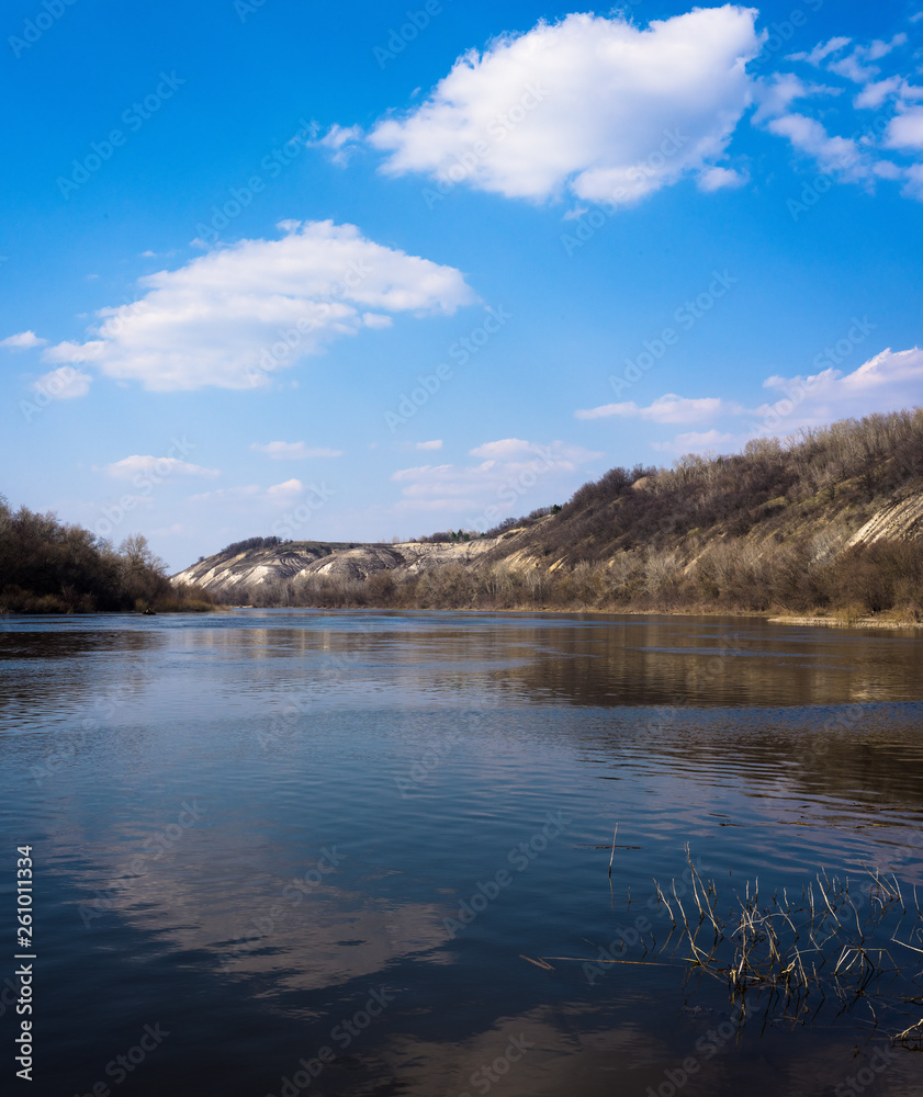 panorama of the river. wide channel, blue sky. mountain shore