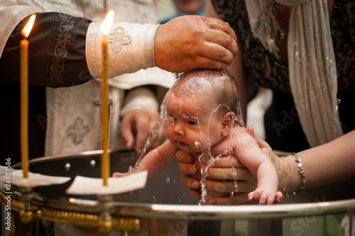 Canvas Print Newborn baby baptism in Holy water