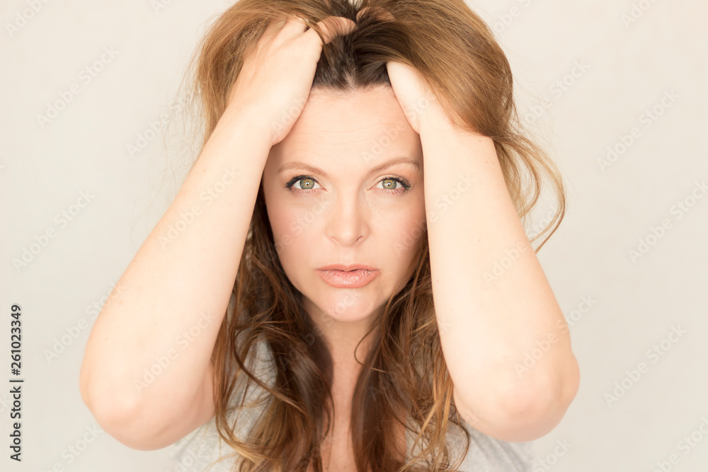 Annoyed stressed woman. Irritated girl on grey studio background Annoyed stressed woman. Irritated girl on grey studio background