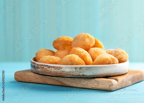 Baursak - traditional Kazakh (Asia) food \ national bread in plate on blue wooden background, top view photo