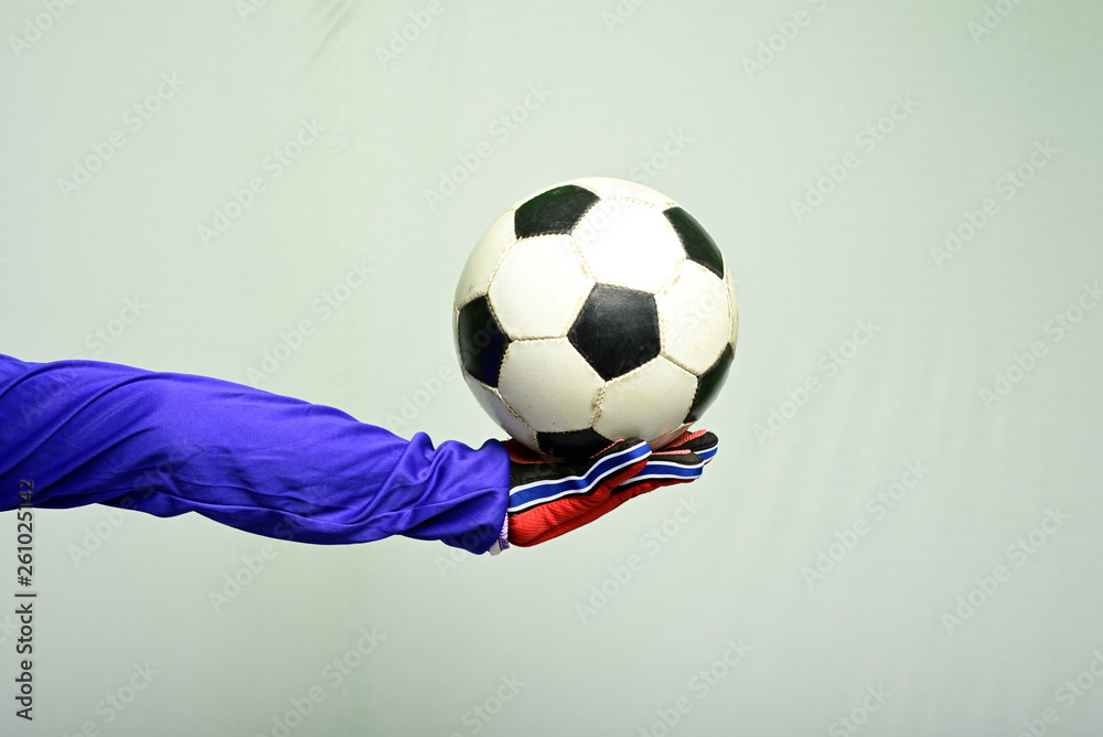 Close-up of soccer ball in goal against gray background