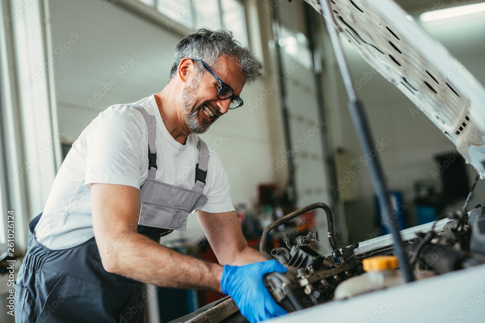 senior worker in car service