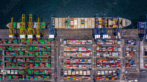 Aerial top view container cargo ship unloading in import export business logistic and transportation of international by container cargo ship in the open sea.