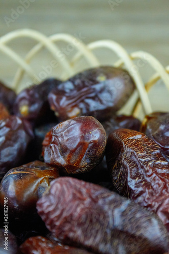 sweet algerian arabic dates fruits on wooden basket