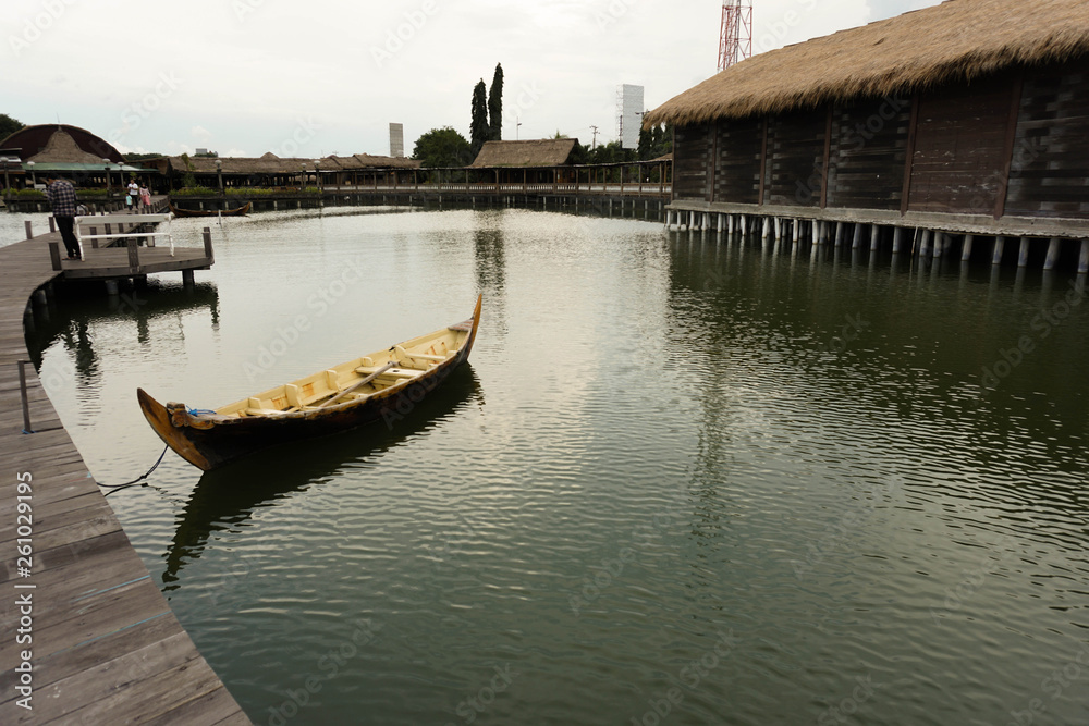 Traditional boats are leaning on a quiet dock. It's boardwalk type dock Traditional boats are leaning on a quiet dock. It's boardwalk type dock