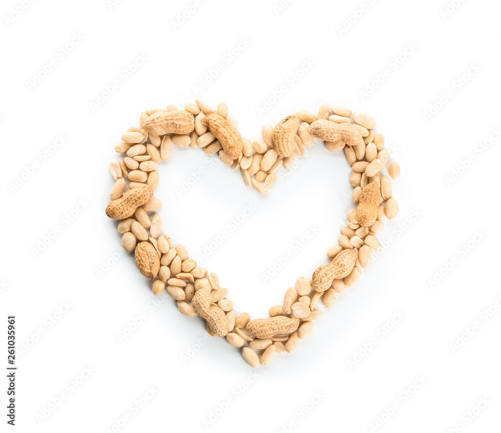 Heart-shaped frame made of tasty peanuts on white background