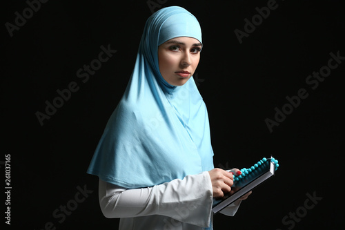 Muslim woman with Koran and...