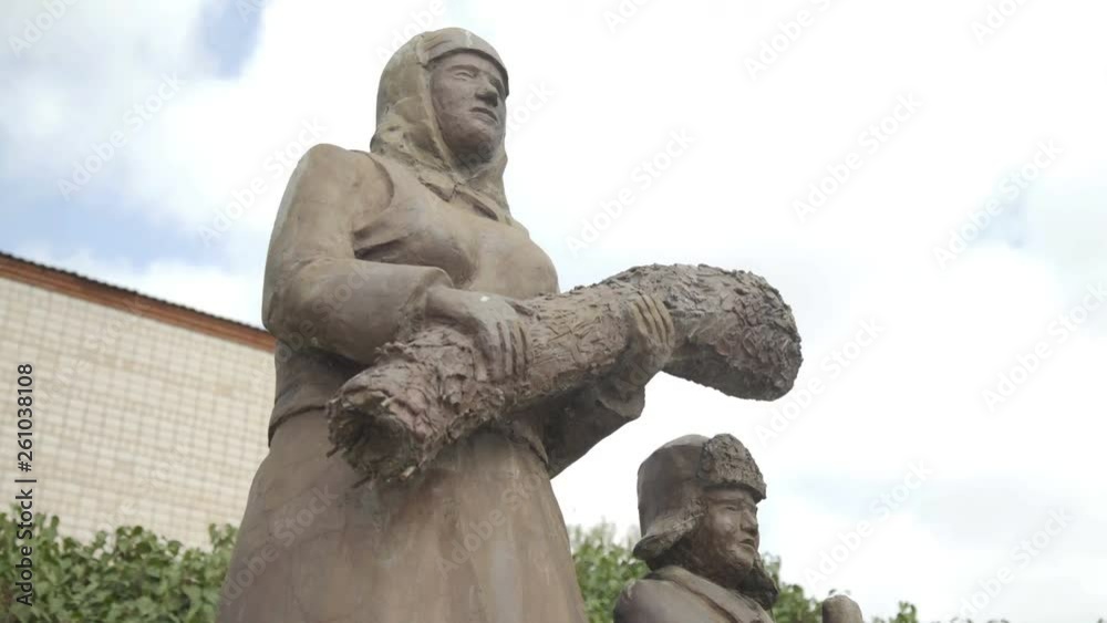 Sculptures of workers of rear during World War II in park of russian village. Mother and her son Sculptures of workers of rear during World War II in park of russian village. Mother and her son