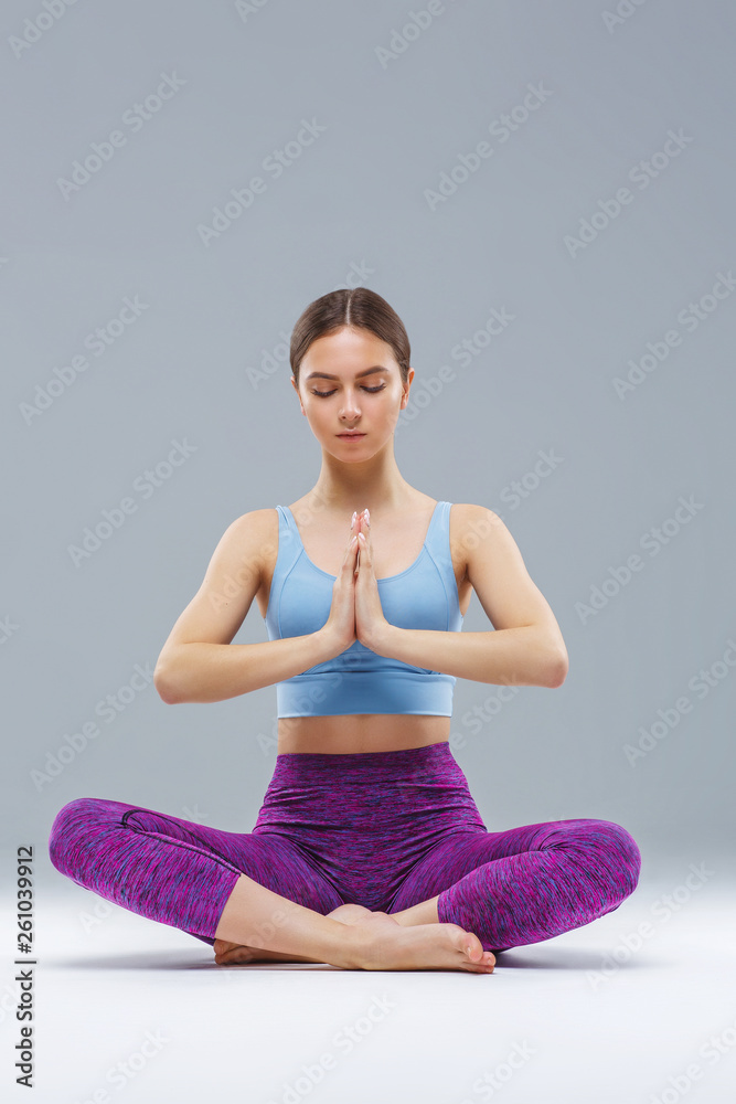 Young girl doing yoga outdoor, studio, gray background Young girl doing yoga outdoor, studio, gray background