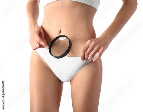 Beautiful young woman in underwear and with magnifier on white background. Epilation concept