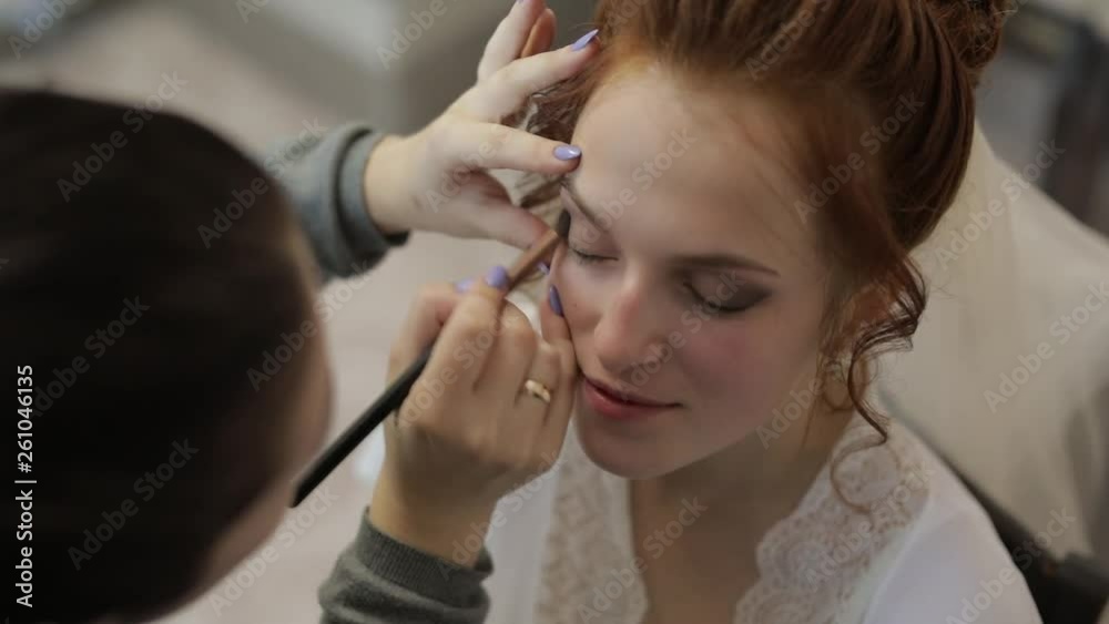 Wedding makeup artist making a make up for bride in veil. Beautiful sexy model Wedding makeup artist making a make up for bride in veil. Beautiful sexy model