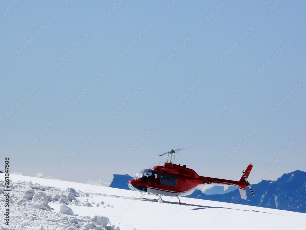 Jungfrau, Switzerland. Red helicopter on high mountain snow
