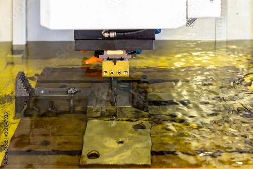 close up workpiece and graphite electrode during working on automatic electrical discharge machine (edm)