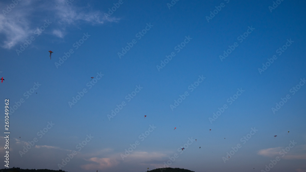 colorful kites flying in the sky during a festival 
