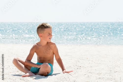 Young boy relaxing on the sea beach. VAcation concept