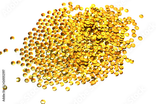 gold sequins scattered on white background
