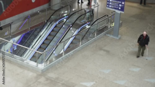 Timelapse people rides on escalator inside railwy or train station, modern airport view from above photo