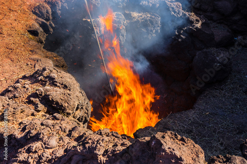 Spain, Lanzarote, Extreme ground heat burning hay in crevice on a volcano in timanfaya national park