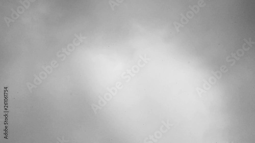 Looking up into the sky with snowflakes falling down.