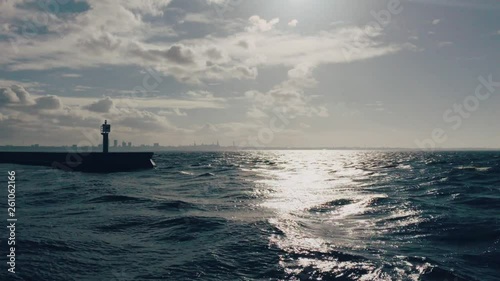 Windy sea with a cityscape of Tallinn Old Town on the horizon.