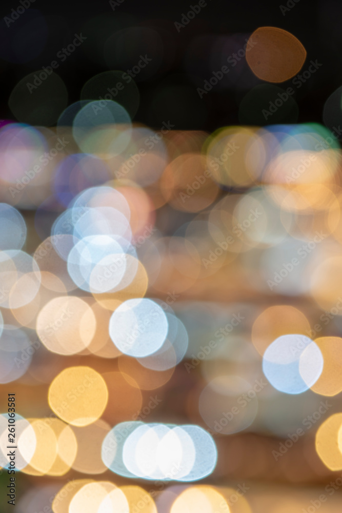 Fototapeta premium Bokeh on a night life in a big city. Soft blurred round bokeh with warm colorful lights.&nbsp;