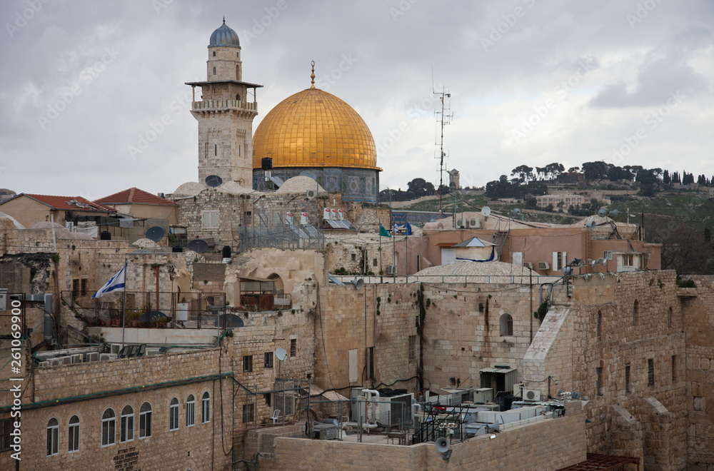 The roofs of the old city of Jerusalem with the Dome of the Rock in the background in cloudy day. Israel