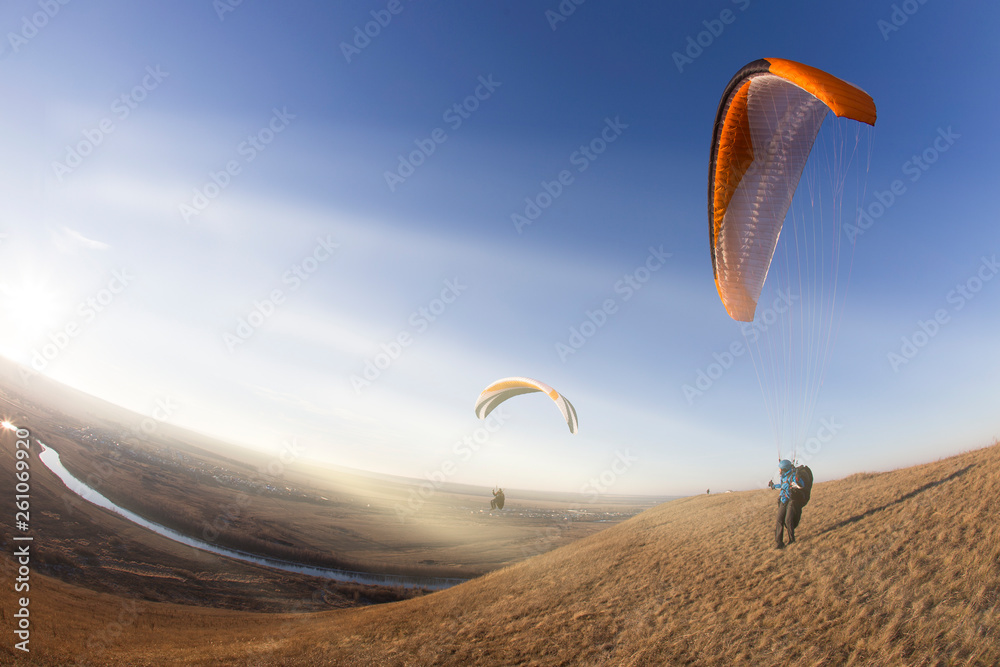 Paraglider during the flight in the sunlight Paraglider during the flight in the sunlight