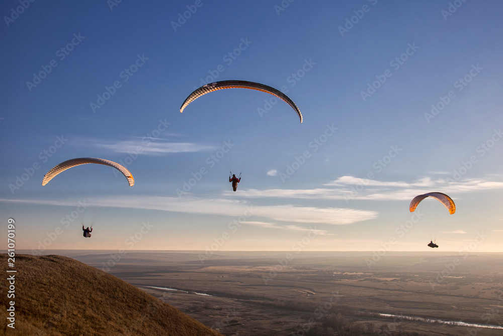 Paraglide with a paraglider in a cocoon against the background of fields of the sky and clouds. Paragliding Sports Paraglide with a paraglider in a cocoon against the background of fields of the sky and clouds. Paragliding Sports