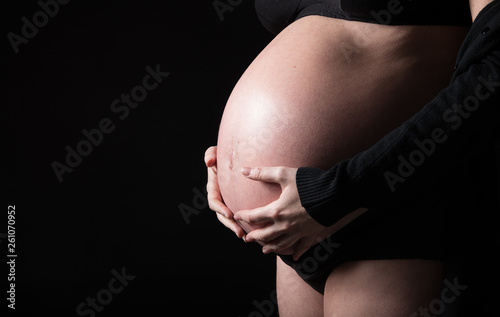 Pregnant woman black background