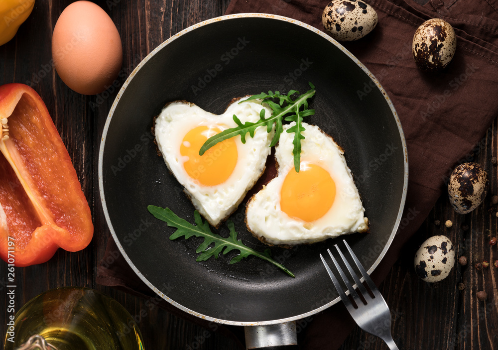 Fried eggs in the form of a heart in a skillet Fried eggs in the form of a heart in a skillet