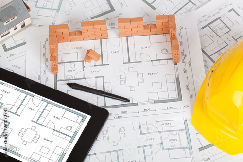 Model house construction with brick on blueprint