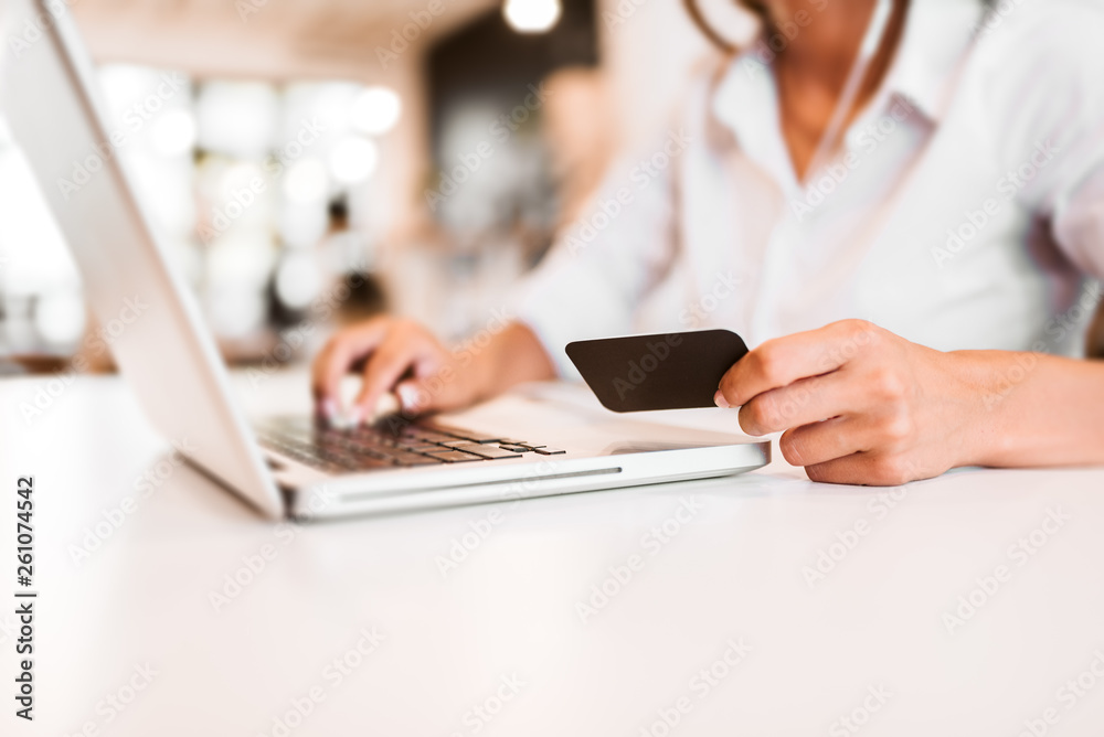 E-commerce concept. Using credit card and laptop for online shopping. Close-up. E-commerce concept. Using credit card and laptop for online shopping. Close-up.