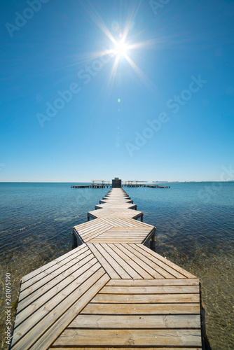 Wooden jetty on the Mar Menor with the sun shining on high  in Murcia  Spain