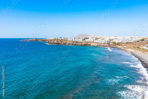 Unique panoramic skyline view of famous Playa Blanca Papagayo region jagged volcanic lava pebble beach, Atlantic ocean south shoreline of Lanzarote, Canary Islands, Spain. Travel vacation concept.