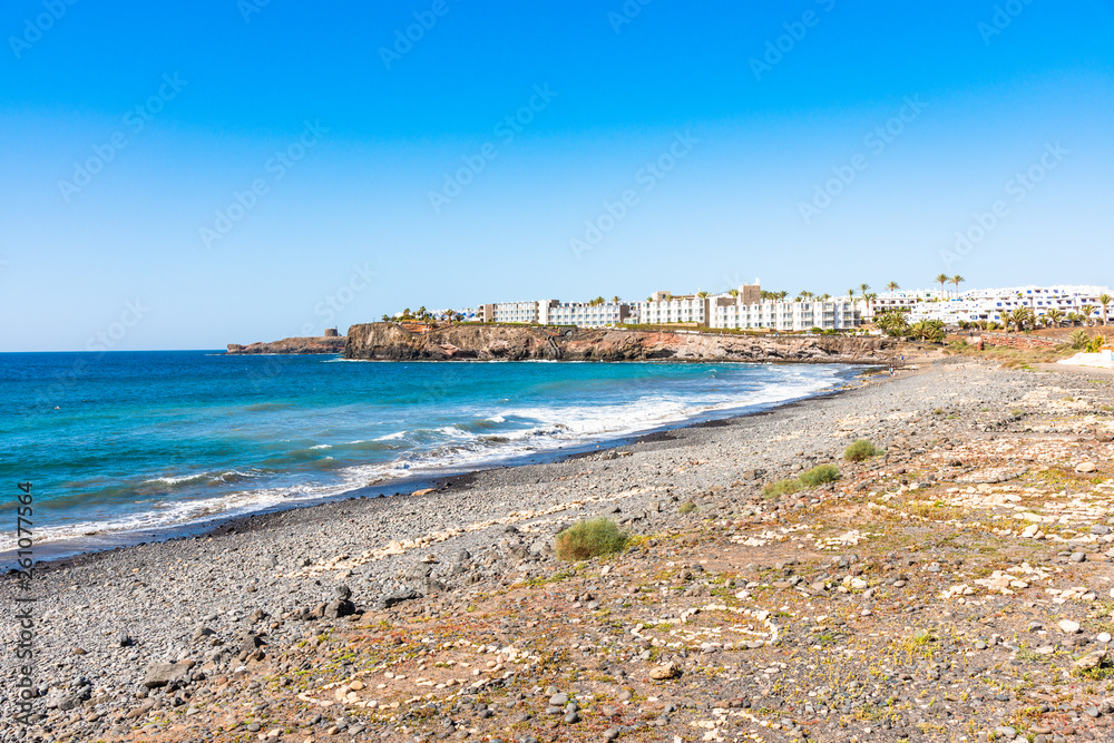 Unique panoramic skyline view of famous Playa Blanca Papagayo region jagged volcanic lava pebble beach, Atlantic ocean south shoreline of Lanzarote, Canary Islands, Spain. Travel vacation concept.