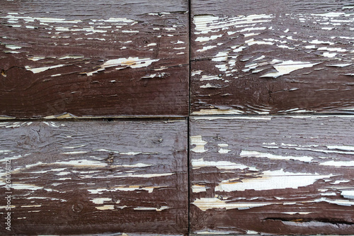 The texture of the board with peeling paint. Abstract background for design. Brown with white rounded boards . Wall panel.