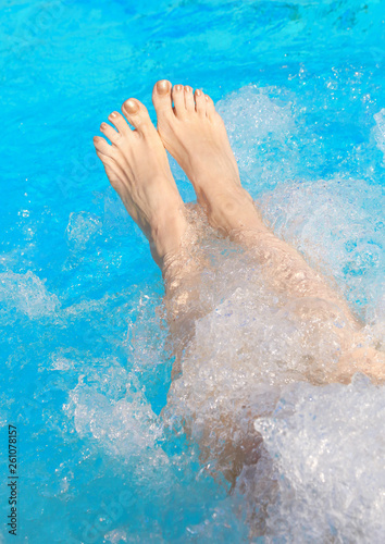 legs of a young woman who relaxes in the hot tub
