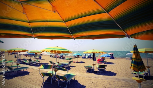 under parasol on the sunny beach photo