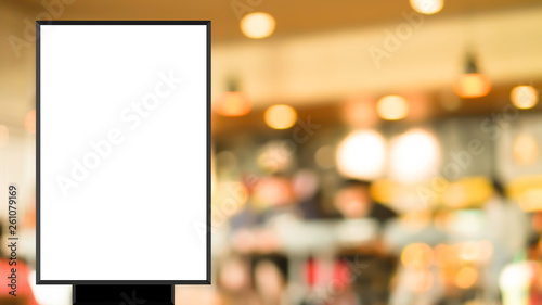 mock up blank white poster standing on blur restaurant background for show or promote promotion 