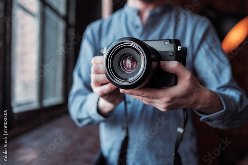 Camera in hand. Close-up of hand holding camera © YURII Seleznov