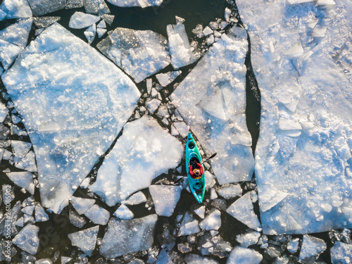 Aerial view of kayaker navigating ice of winter Ontario lake photo