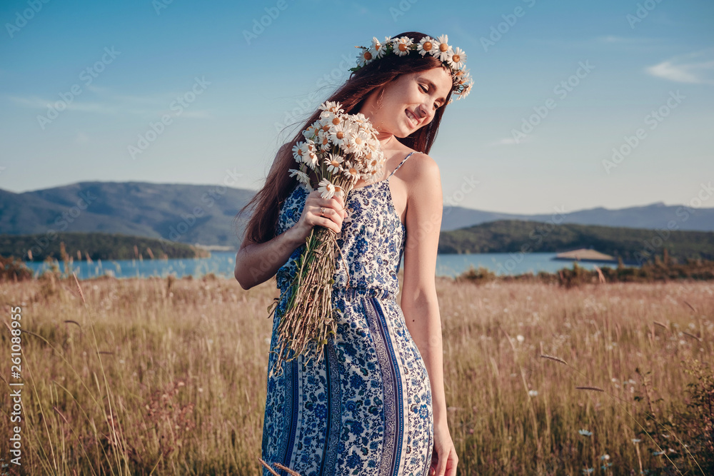 Obraz premium Beautiful woman enjoying field, pretty girl with long dark hair relaxing outdoor